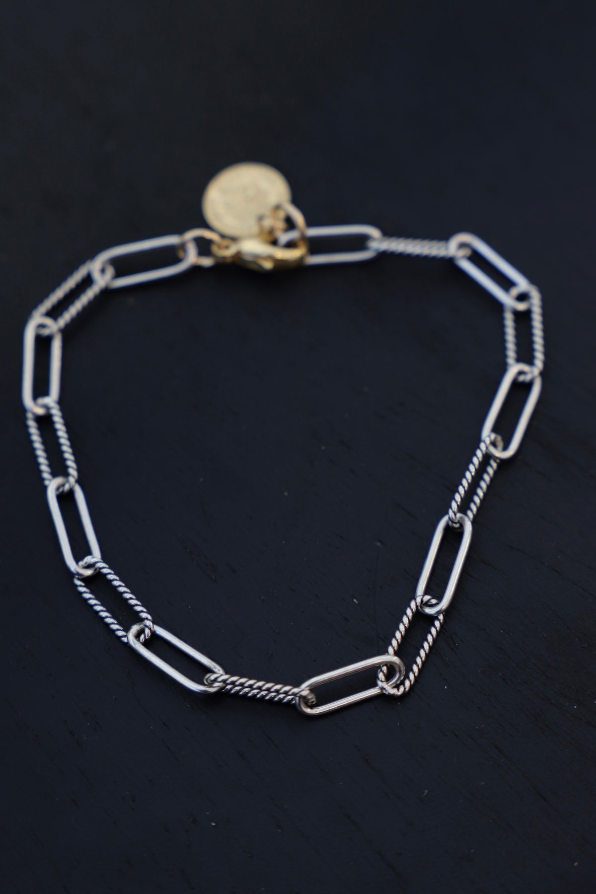 Silver chain bracelet on a black background