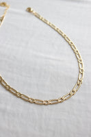 Gold chain necklace on a white background