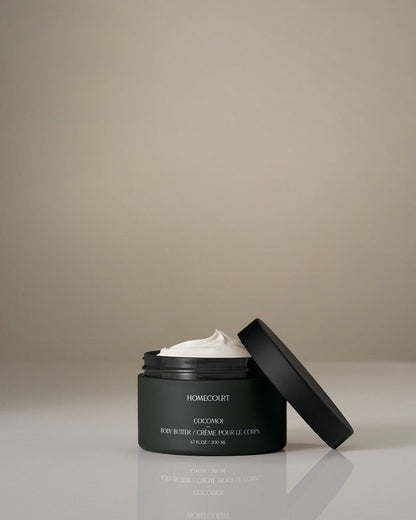 Black jar of Homecourt body butter with a beige background
