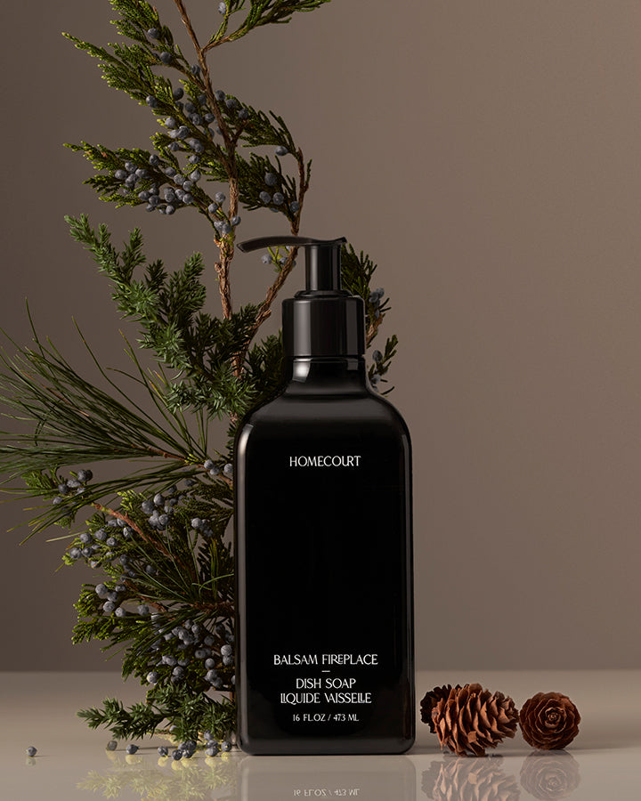 Black Homecourt dish soap bottle with decorative elements on a neutral background