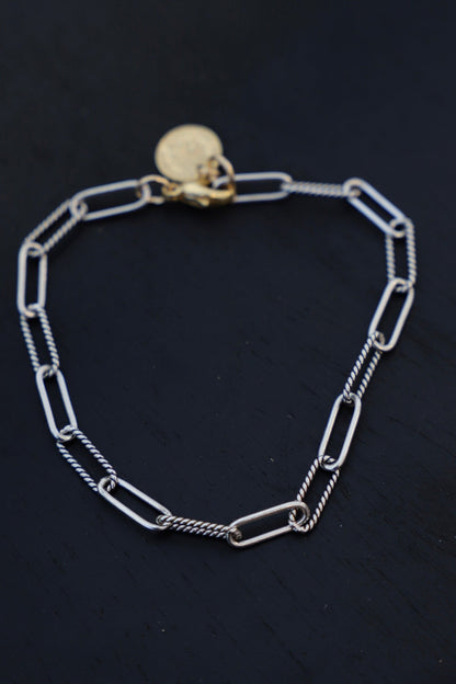 Silver chain bracelet on a black background