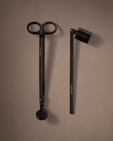 Black scissors and black pen on a brown background