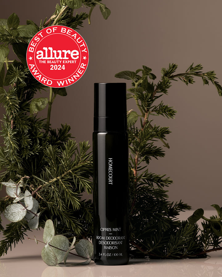 Black deodorant bottle with 'Allure Best of Beauty Award 2024' badge on a neutral background with greenery.