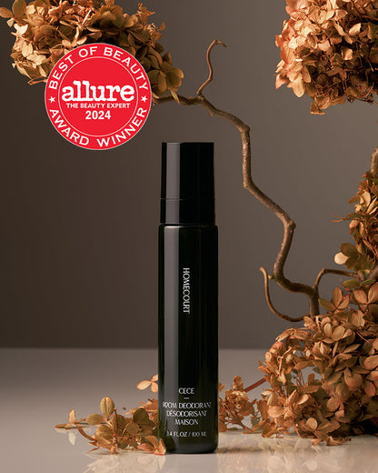 Black bottle with decorative elements and Allure Best of Beauty award badge on a neutral background