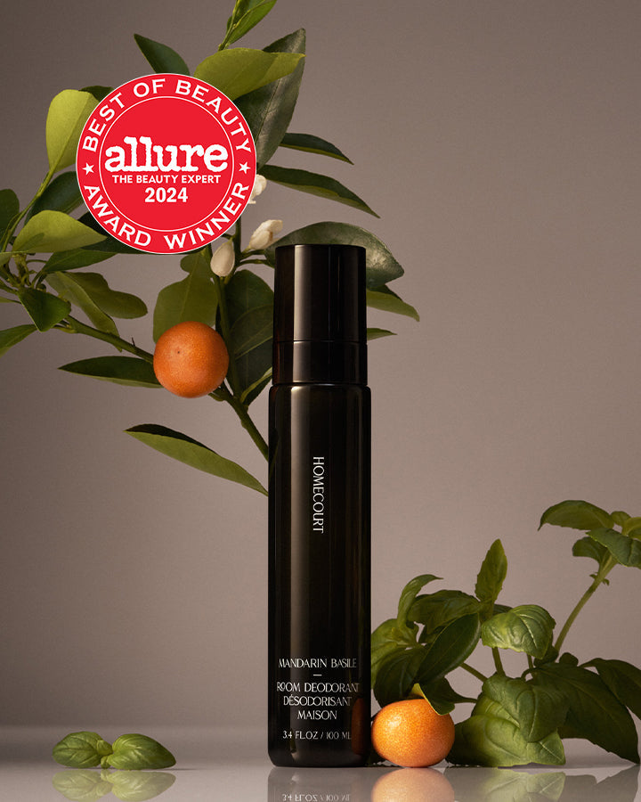 Black bottle with 'allure Best of Beauty Award Winner 2024' badge on a plant background