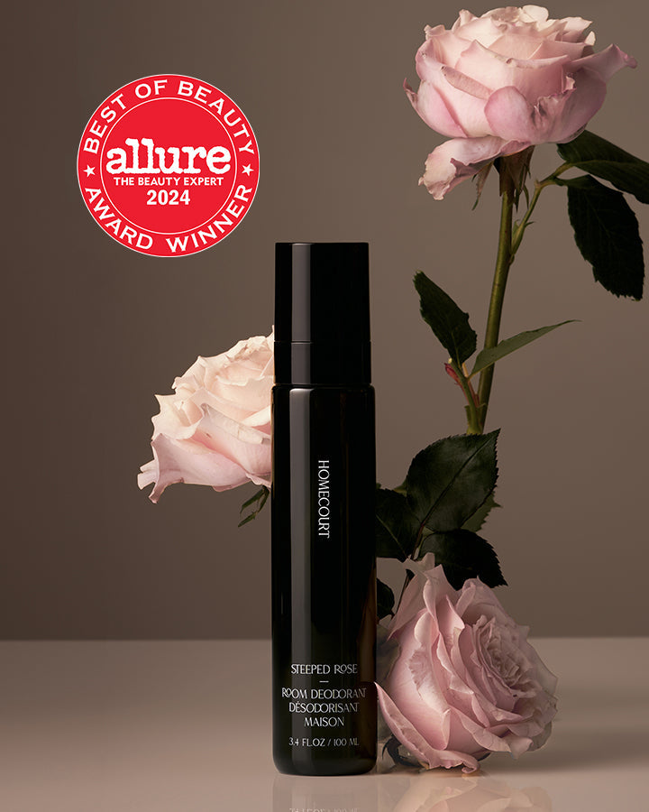 Black bottle with pink roses and Allure Best of Beauty Award badge on a brown background