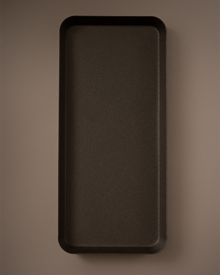 Rectangular dark brown tray on a matching brown background