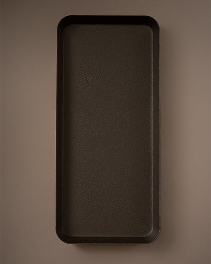 Rectangular dark brown tray on a matching brown background